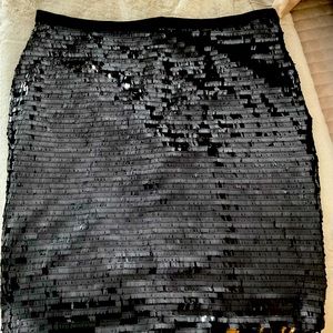 The sequined skirt hits right above the knee. Straight skirt line.  NWOT.